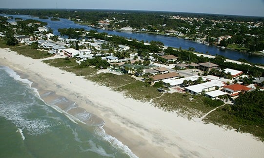 Aerial view showing beach at Casey Key Bayfront home with guest house